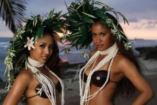 a woman standing next to a body of water