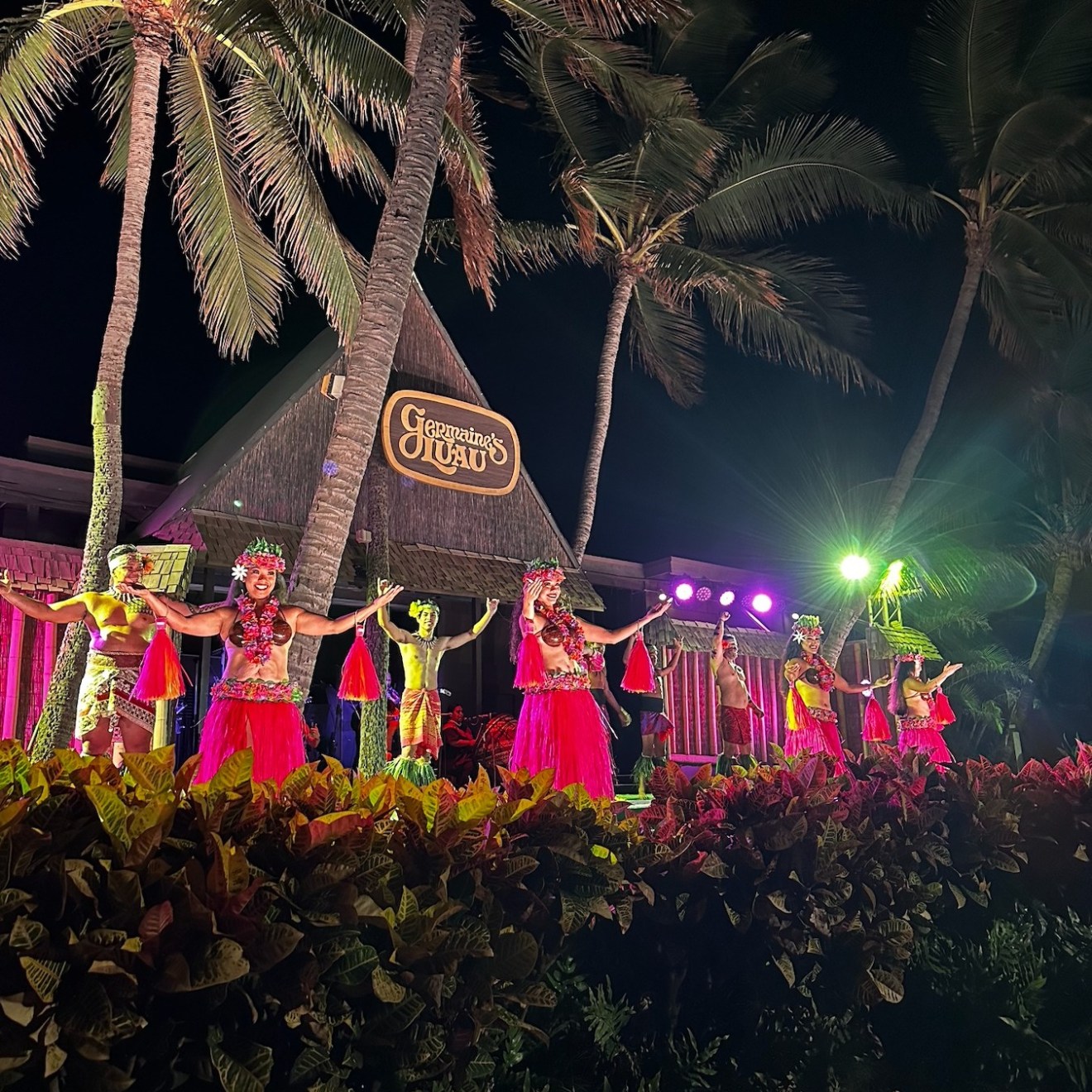 a group of people standing in front of a christmas tree