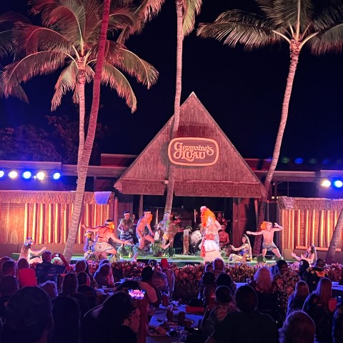 a group of people on a stage in front of a crowd